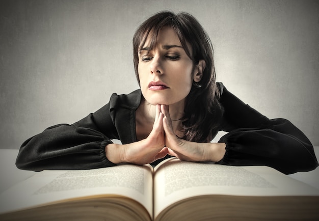 woman studying on a big book 