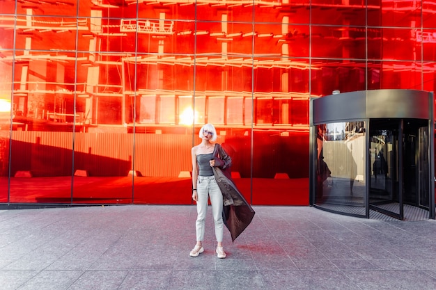 Woman in stylish glasses on a red.