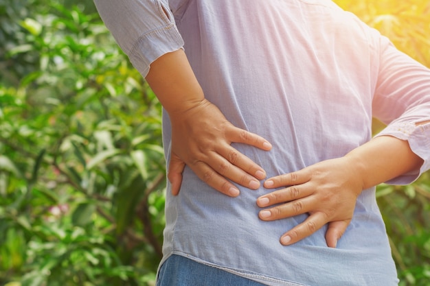 woman suffering from backache at outdoor