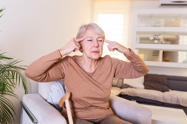 Woman suffering from stress or a headache grimacing in pain.