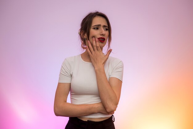 Woman suffering with toothache. She's holding her hand on face and feeling pain