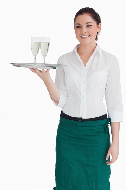 Woman in suit holding a tray with glasses