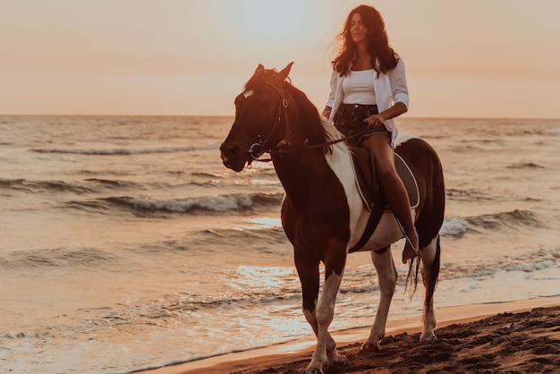 A woman in summer clothes enjoys riding a horse on a beautiful\
sandy beach at sunset. selective focus. high quality photo