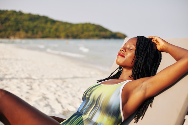 Woman sunbathing on beach