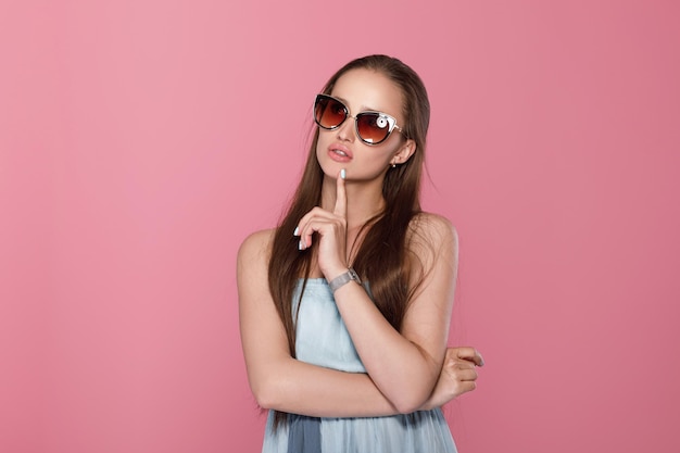 Woman in sunglasses and blue dress dreams