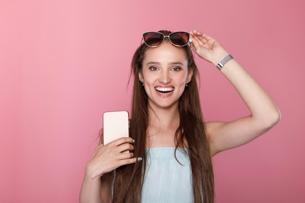 Woman in sunglasses using smartphone