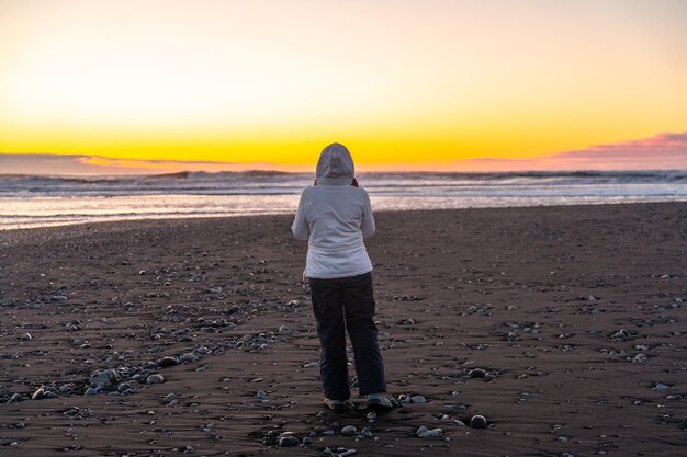 Woman at sunrise on Diamond Beach on vacation in Iceland