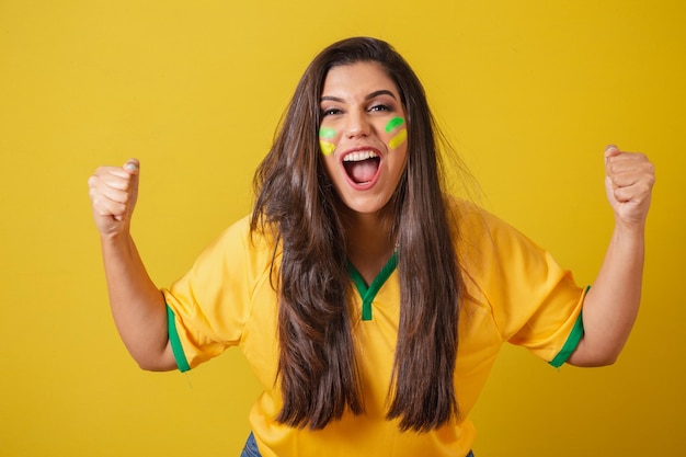 Woman supporter of brazil 2022 world cup football championship\
screaming goal celebrating team victory and goal