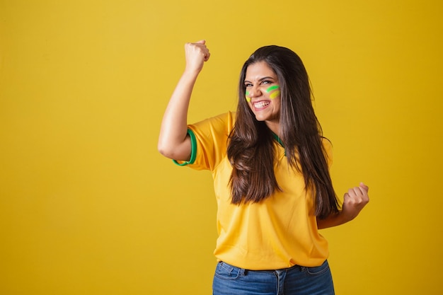 Woman supporter of Brazil world cup 2022 football championship celebrating partying