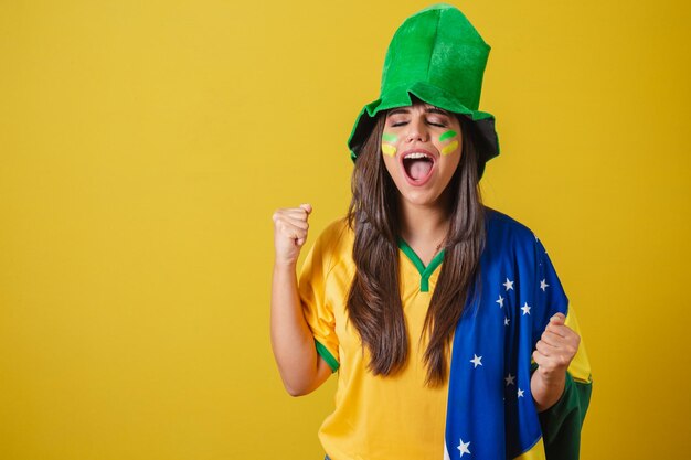 Woman supporter of Brazil world cup 2022 screaming goal celebrating partying amazing