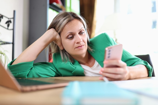 Woman surfing internet on smartphone in office