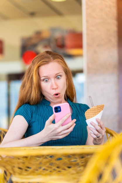 Woman surprised by something she is looking at with her smartphone