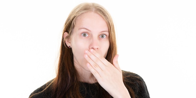 Woman surprised hand over mouth posing in white background studio