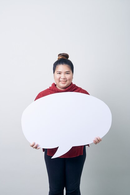 Photo woman in sweater holding empty speech bubble