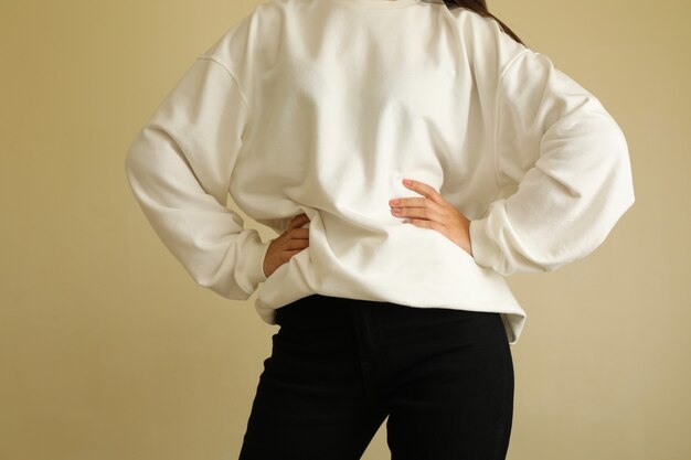 Woman in sweatshirt keep hands on belt