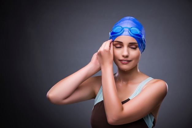 Woman swimmer against grey background