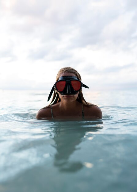 Woman swimming in the ocean with scuba diving eqipment