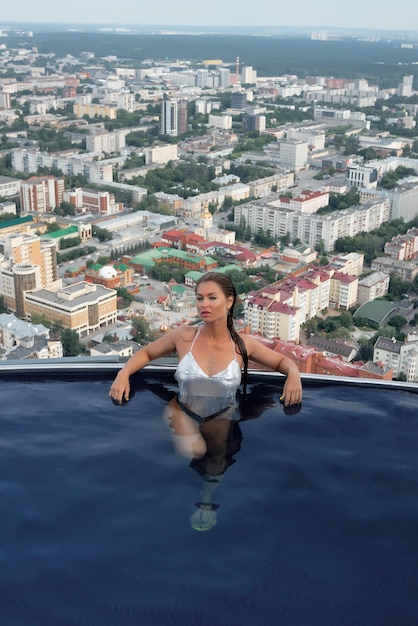 Woman in swimming pool on roof