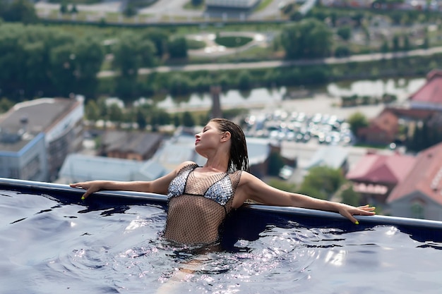 Woman in swimming pool on roof