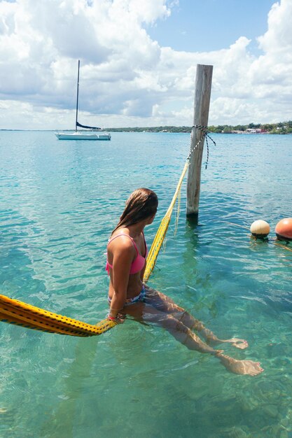 Woman swimming in sea against sky