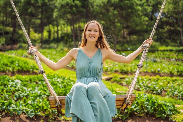 Woman on a swing in the garden