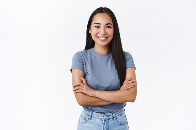 woman in t-shirt, cross hands chest in determined, confident pose, smiling enthusiastic