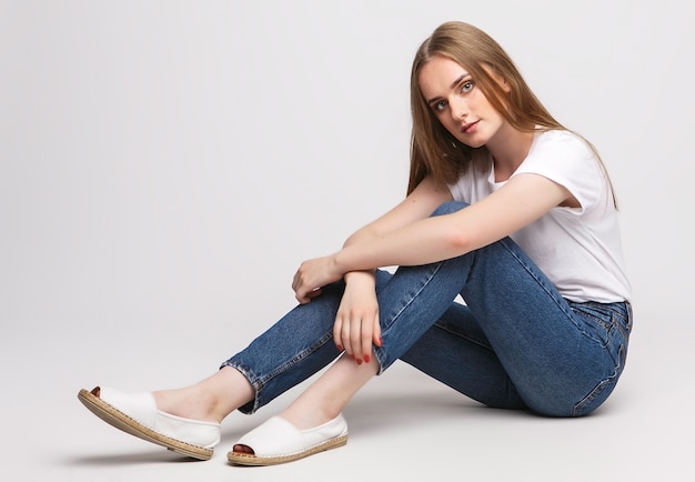 Woman in a t-shirt and jeans isolated