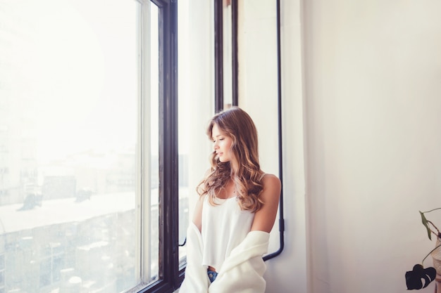  woman in t-shirt near window