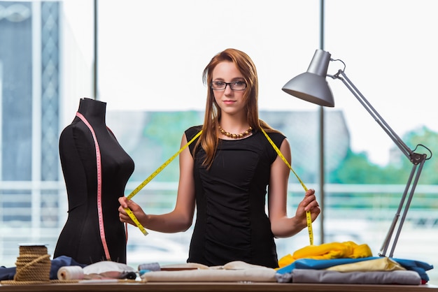 Woman tailor working on new clothing