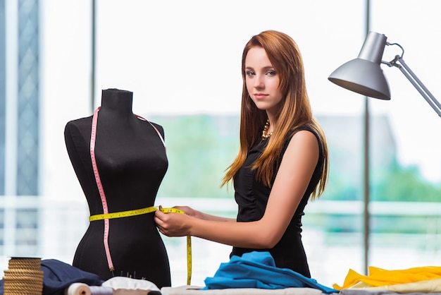 Woman tailor working on new clothing