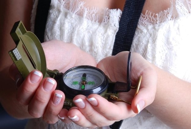 Woman takes a compass in hands