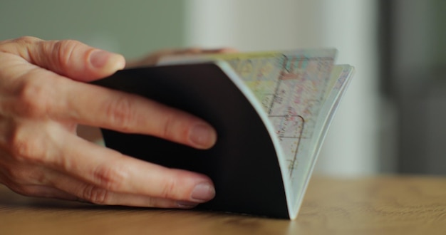 Woman takes a passport in hand and puts a entry stamp To give the entry visa Visa stamp in passport ID Entry in foreign country