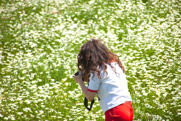 カモミール畑で写真を撮る女性