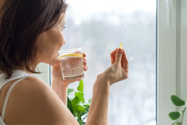 Woman takes pill with omega 3