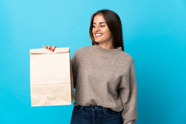 Woman taking a bag of takeaway food isolated