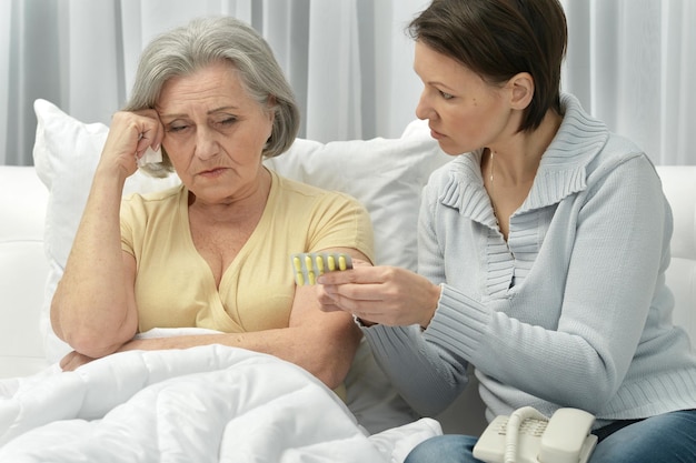 Woman taking care of ill woman