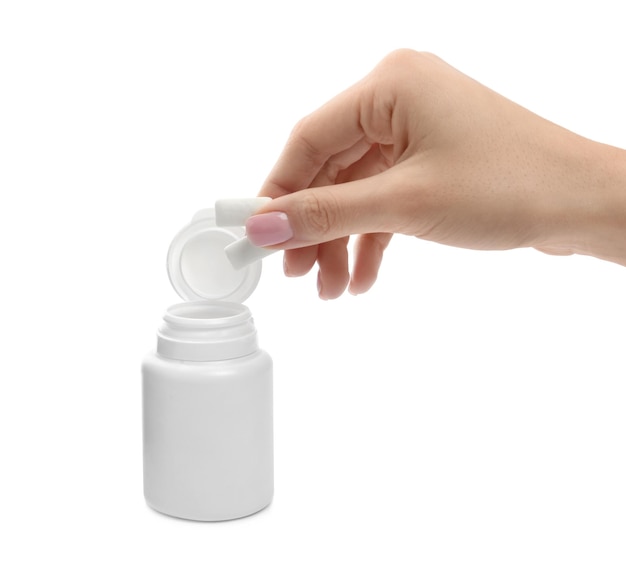 Woman taking chewing gum pieces from jar on white background closeup