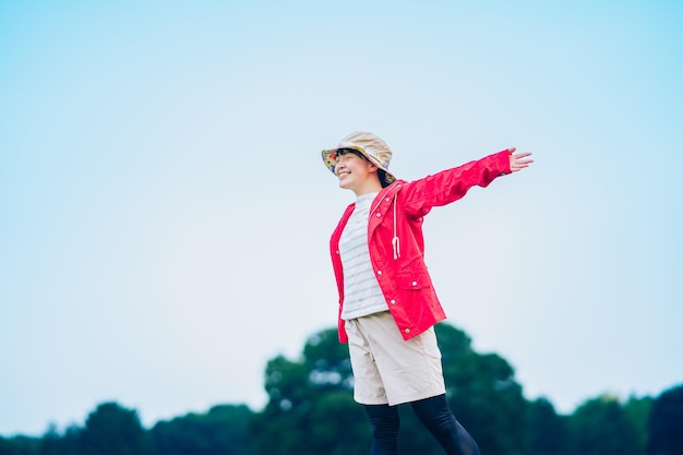 A woman taking a deep breath in the meadow