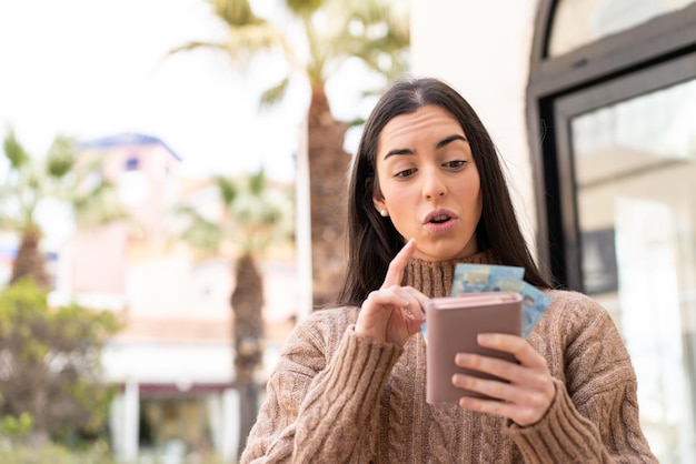 Woman taking a lot of money at outdoors