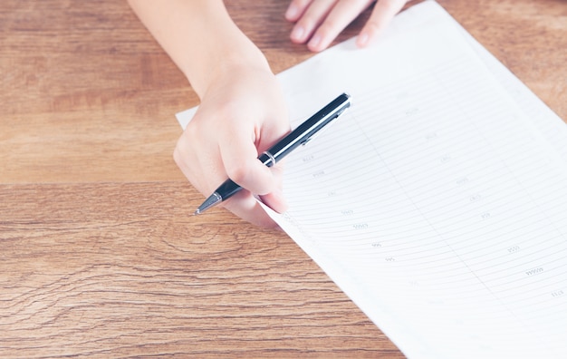 woman taking notes in papers