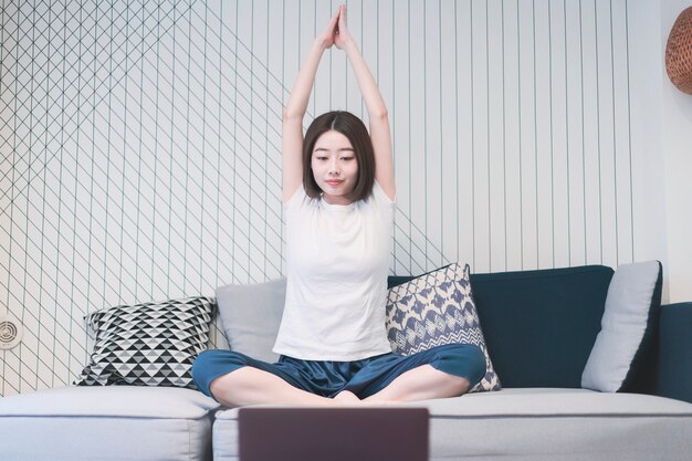 Woman taking an online yoga lesson