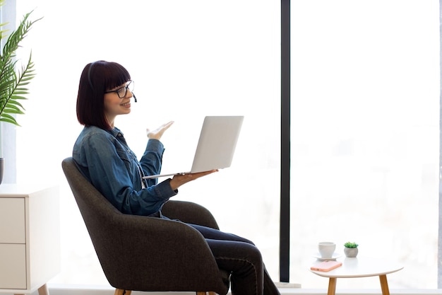 Woman taking part in online briefing using digital devices