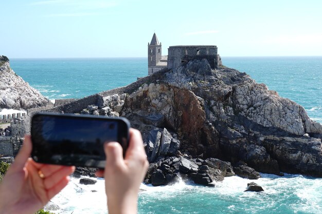 A woman taking a photo of the landscape Horizontal photo