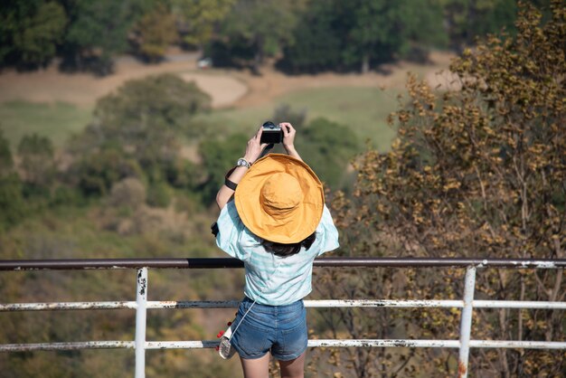 Woman taking photos in the mountains