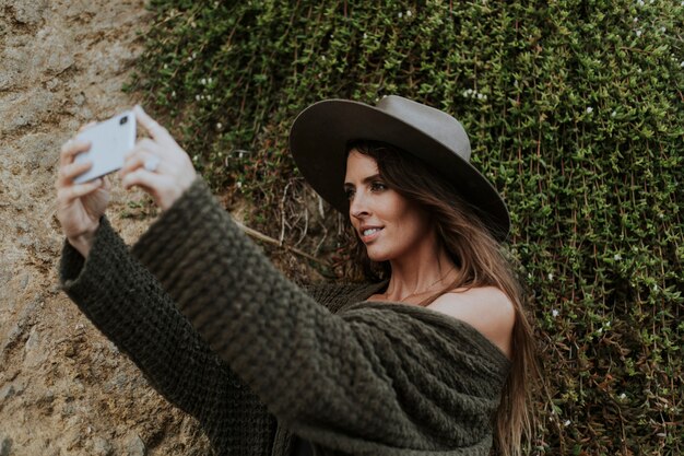 Una donna che scatta foto con il suo telefono