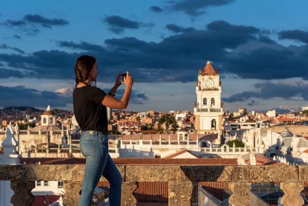 Woman taking pictures of the views over Sucre, Bolivia