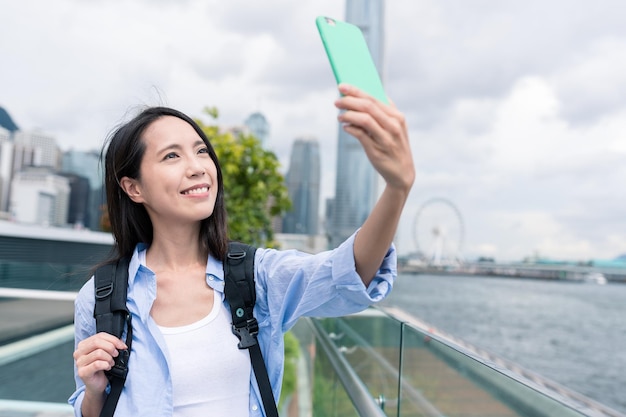 Woman taking selfie by mobile phone in Hong Kong