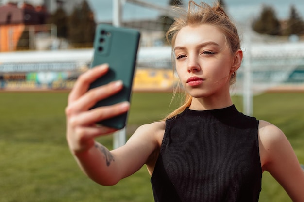 Woman taking selfie on stadium