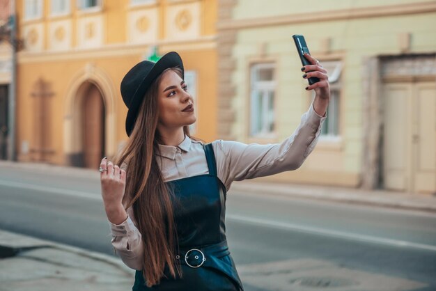 Woman taking selfie with her smartphone