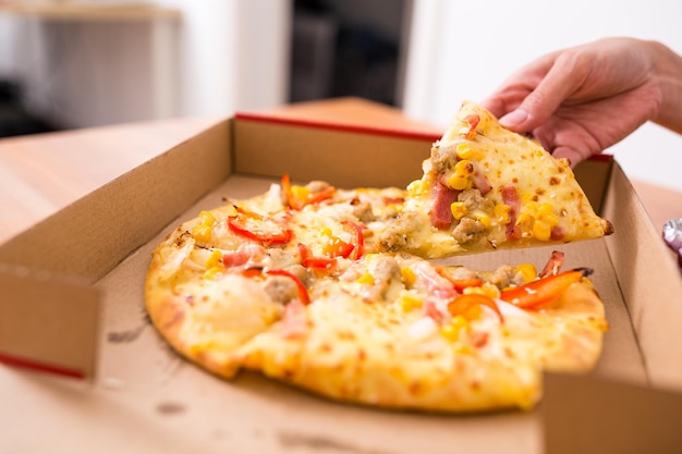 Woman taking on slice from pizza